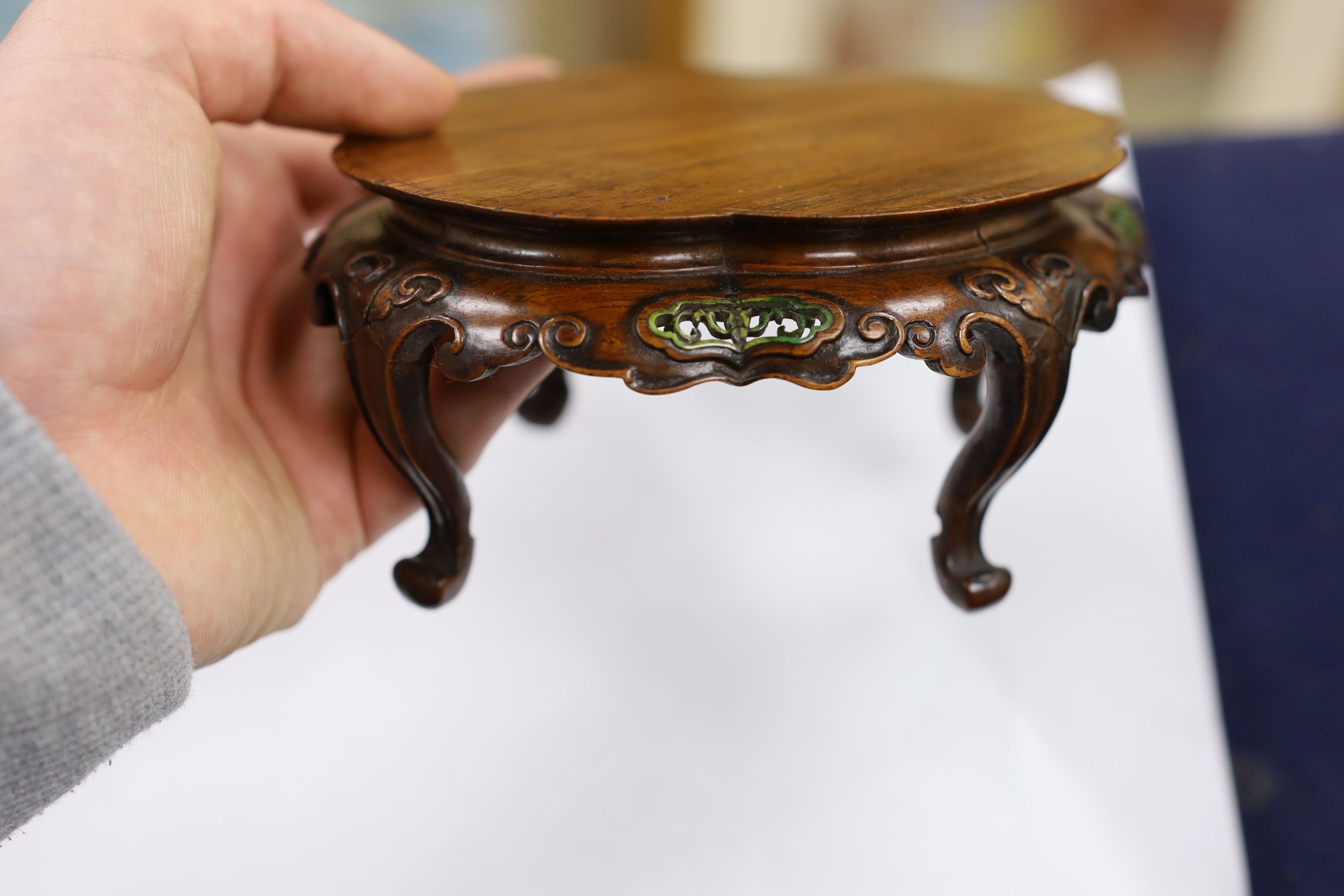 A fine Chinese oval hardwood and green stained Ivory inset stand, Qing dynasty, lacking stretcher, 15 cms wide.